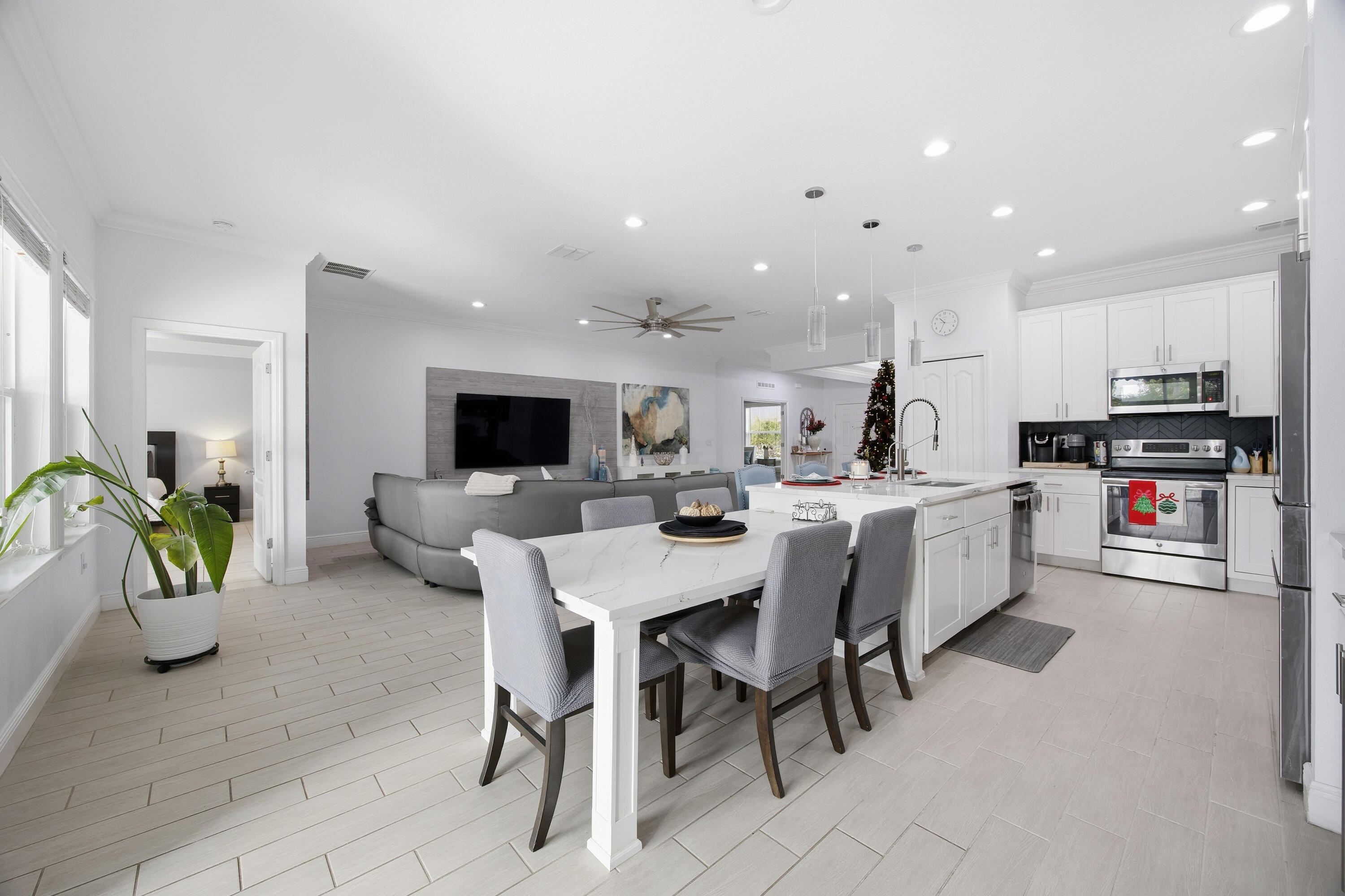 2758 Southwest Onaway Avenue Port St. Lucie, FL 34987 - Photo 18 of 49 a living room with stainless steel appliances furniture a flat screen tv and a window