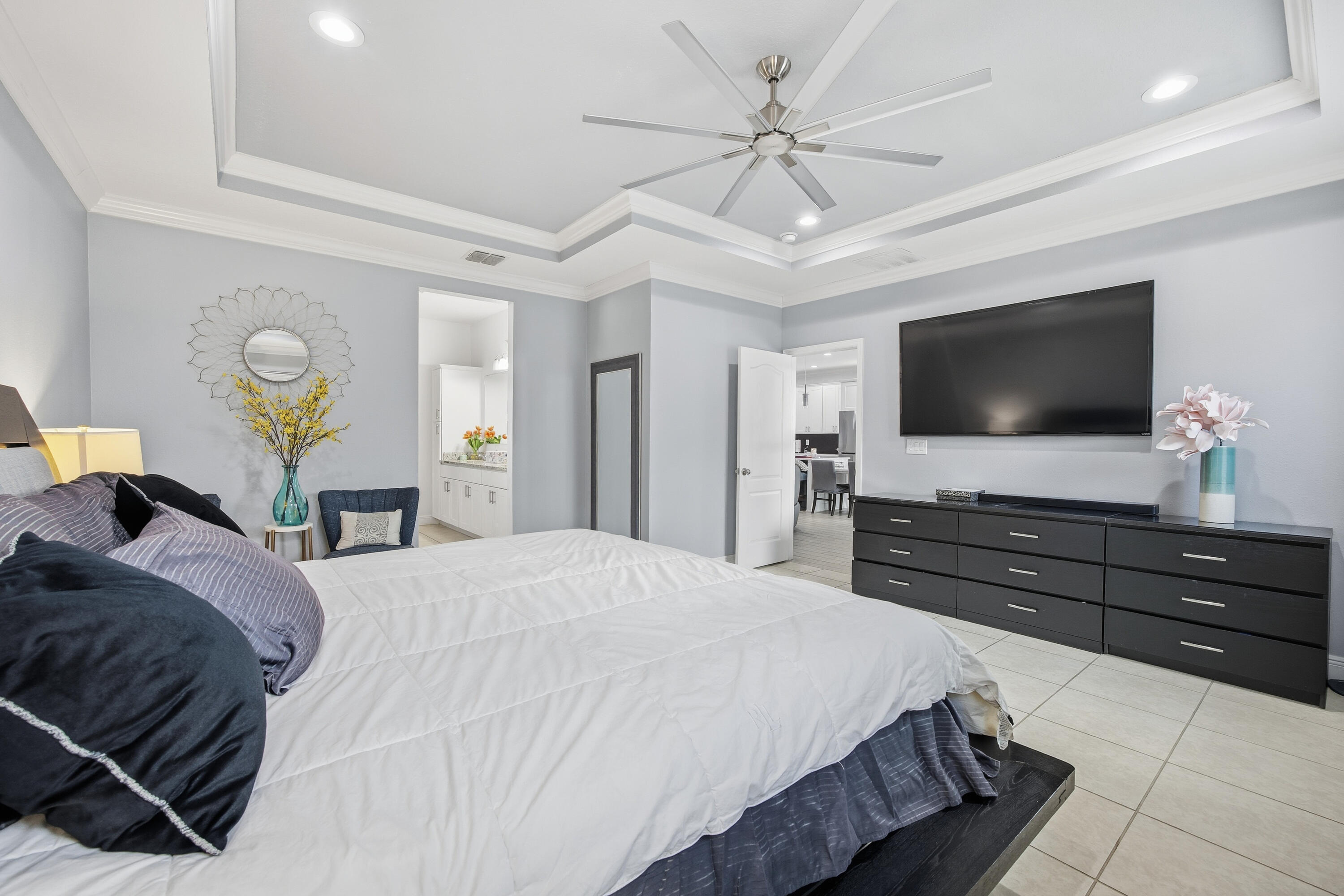 2758 Southwest Onaway Avenue Port St. Lucie, FL 34987 - Photo 22 of 49 a bedroom with a bed and a flat tv screen on dresser