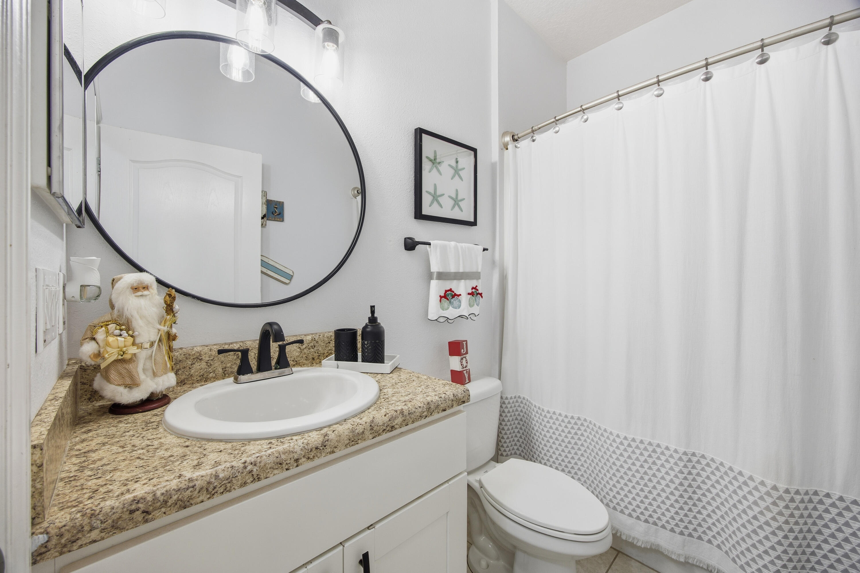 2758 Southwest Onaway Avenue Port St. Lucie, FL 34987 - Photo 27 of 49 a bathroom with a sink a toilet and a mirror