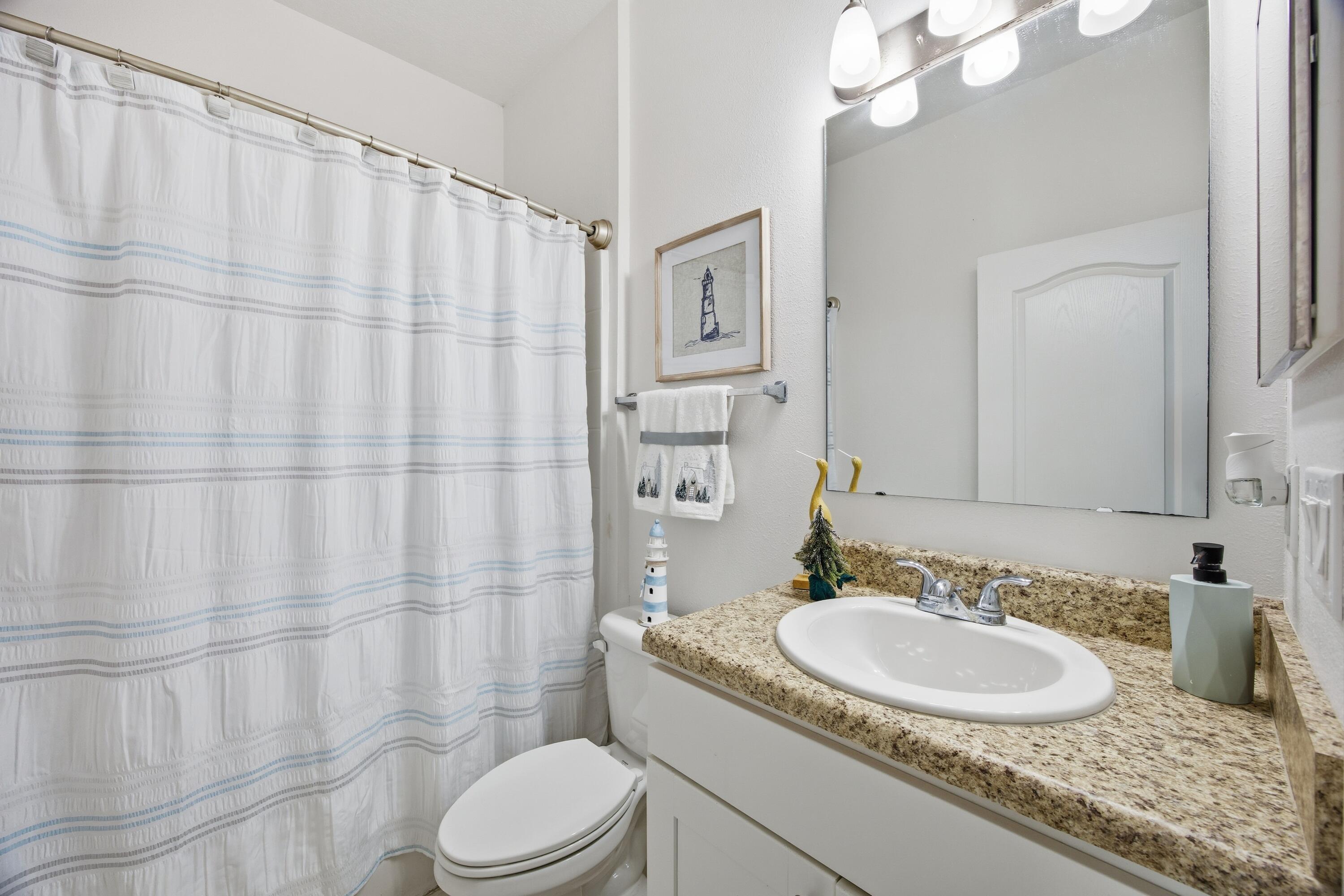 2758 Southwest Onaway Avenue Port St. Lucie, FL 34987 - Photo 29 of 49 a bathroom with a granite countertop sink a toilet and a mirror