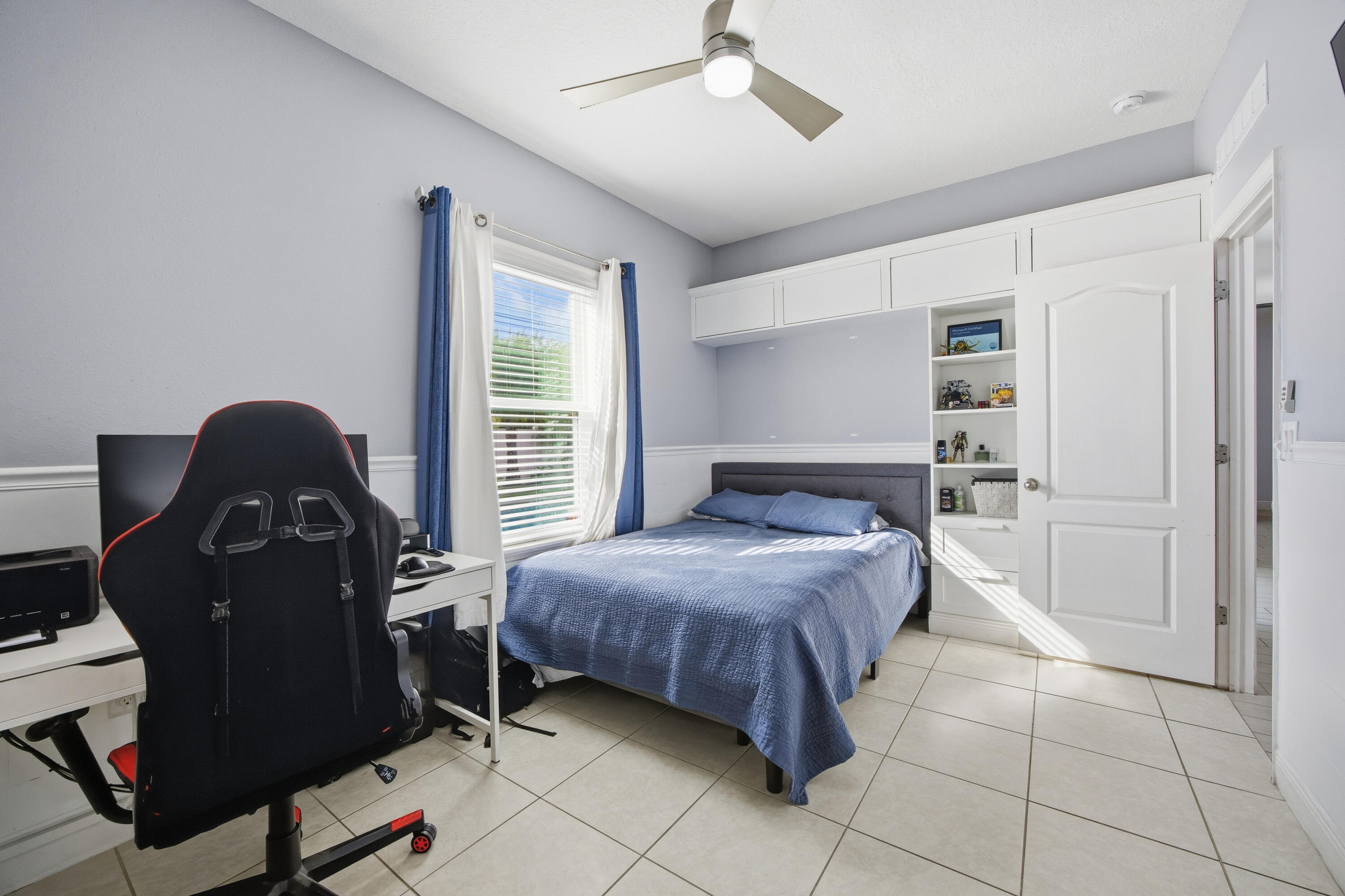 2758 Southwest Onaway Avenue Port St. Lucie, FL 34987 - Photo 30 of 49 a bedroom with a bed and a cabinets