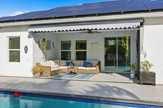 a outdoor living space with furniture and white walls