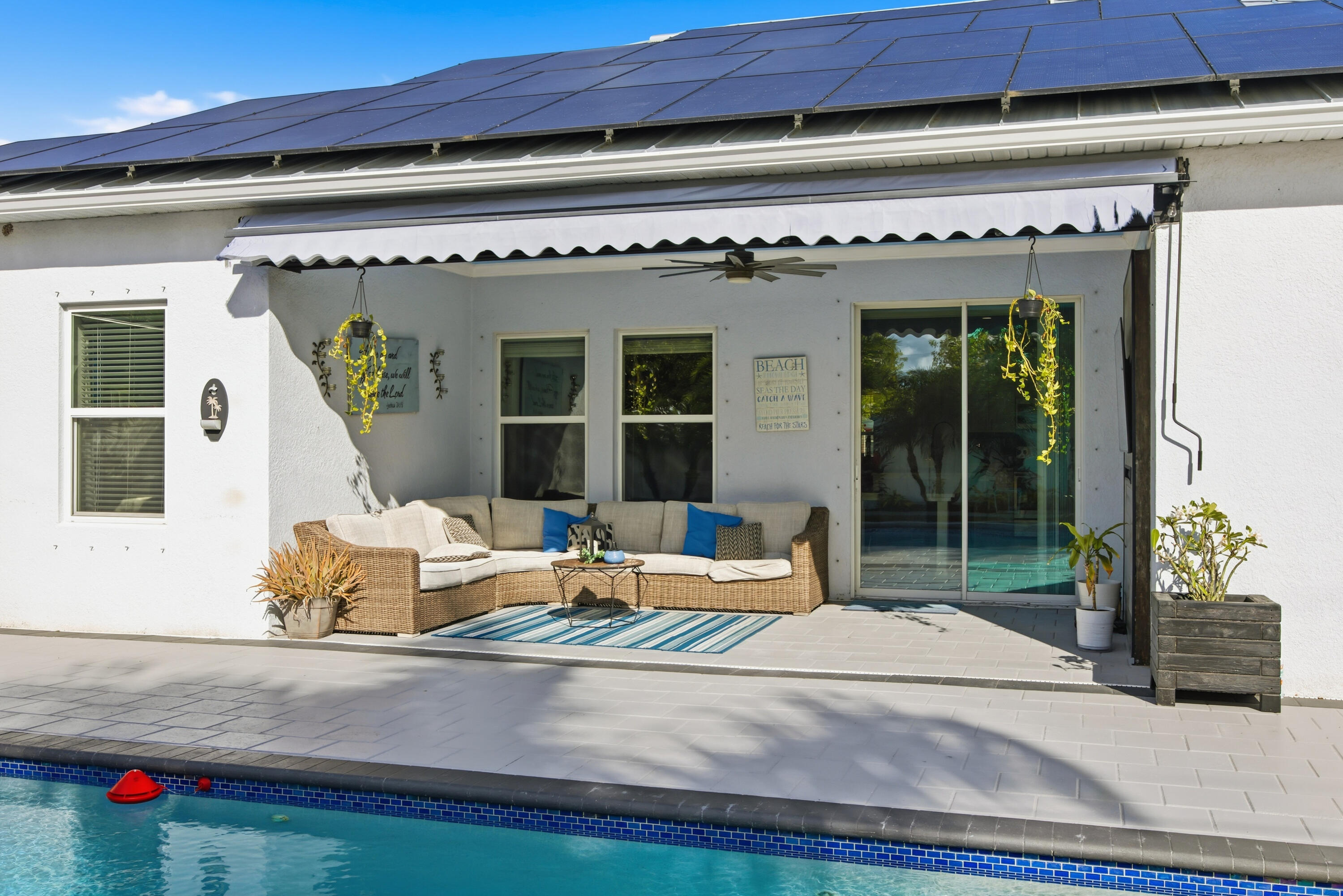 2758 Southwest Onaway Avenue Port St. Lucie, FL 34987 - Photo 34 of 49 a outdoor living space with furniture and white walls