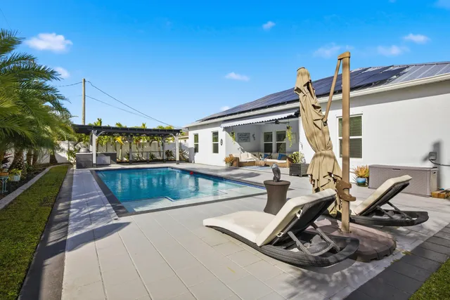 a view of a swimming pool with sitting area