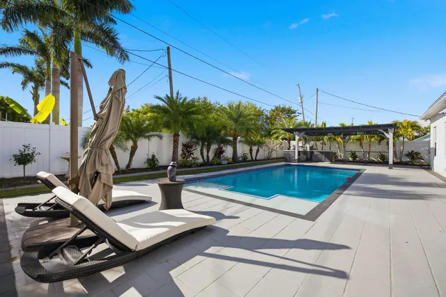 a view of a swimming pool with lounge chair