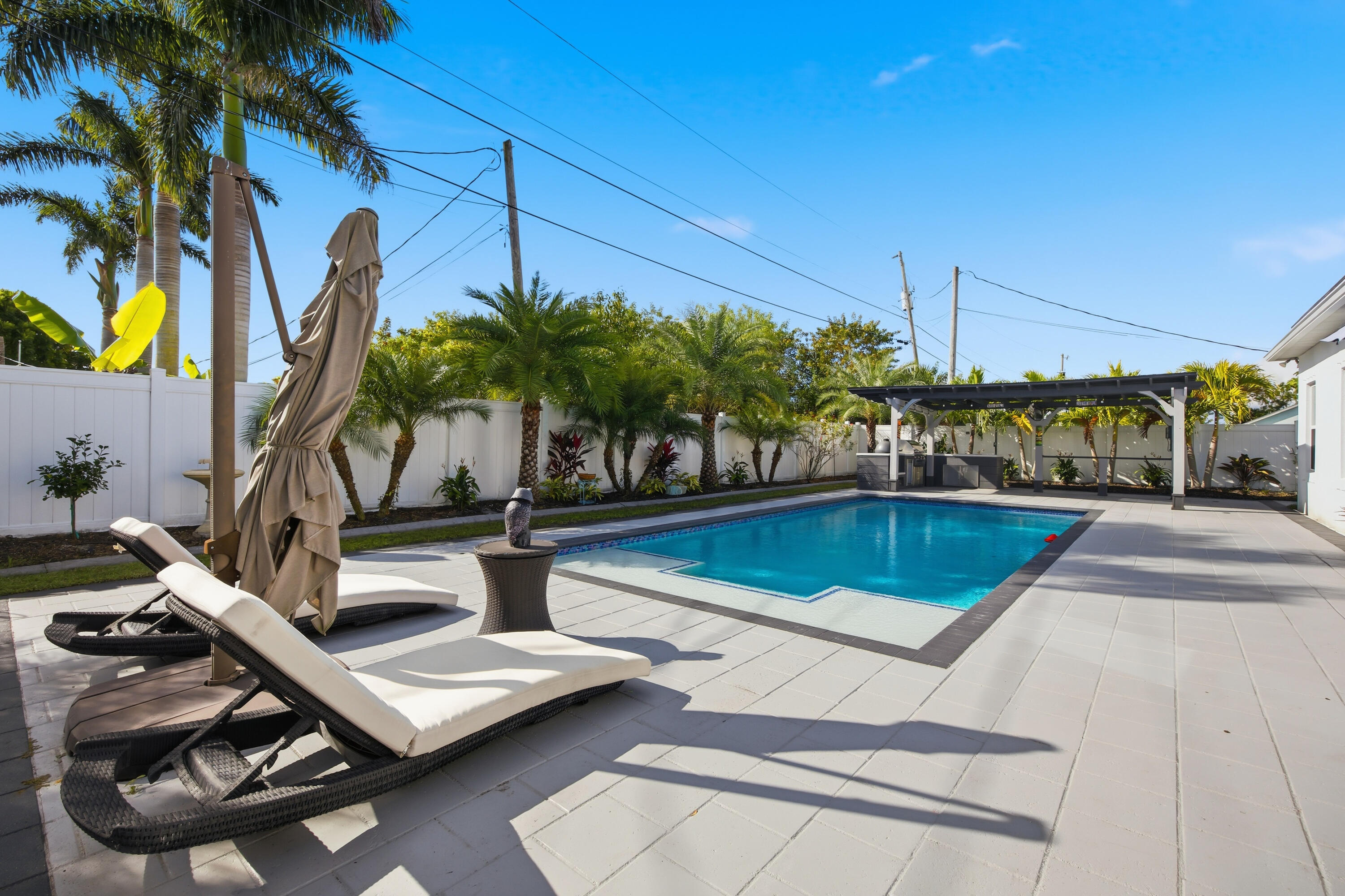 2758 Southwest Onaway Avenue Port St. Lucie, FL 34987 - Photo 37 of 49 a view of a swimming pool with lounge chair