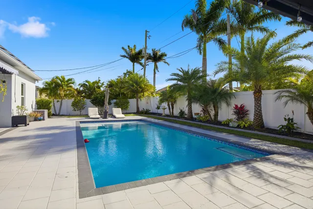 a swimming pool with outdoor seating and yard