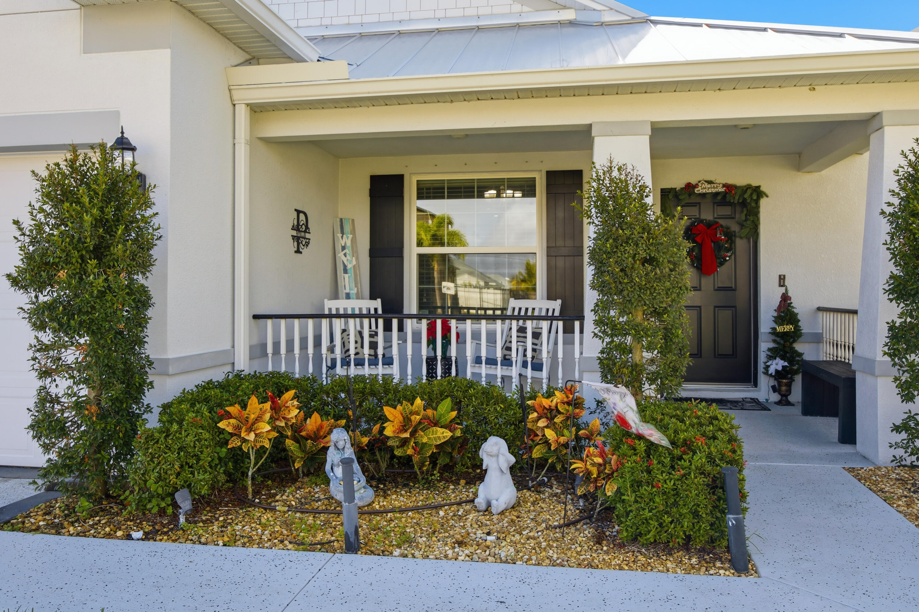 2758 Southwest Onaway Avenue Port St. Lucie, FL 34987 - Photo 4 of 49 a view of a porch with a flower garden