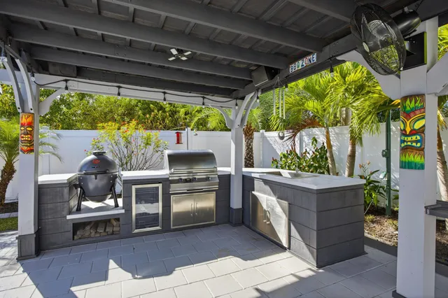a living room with a couch a lawn chair and a dining table with garden view