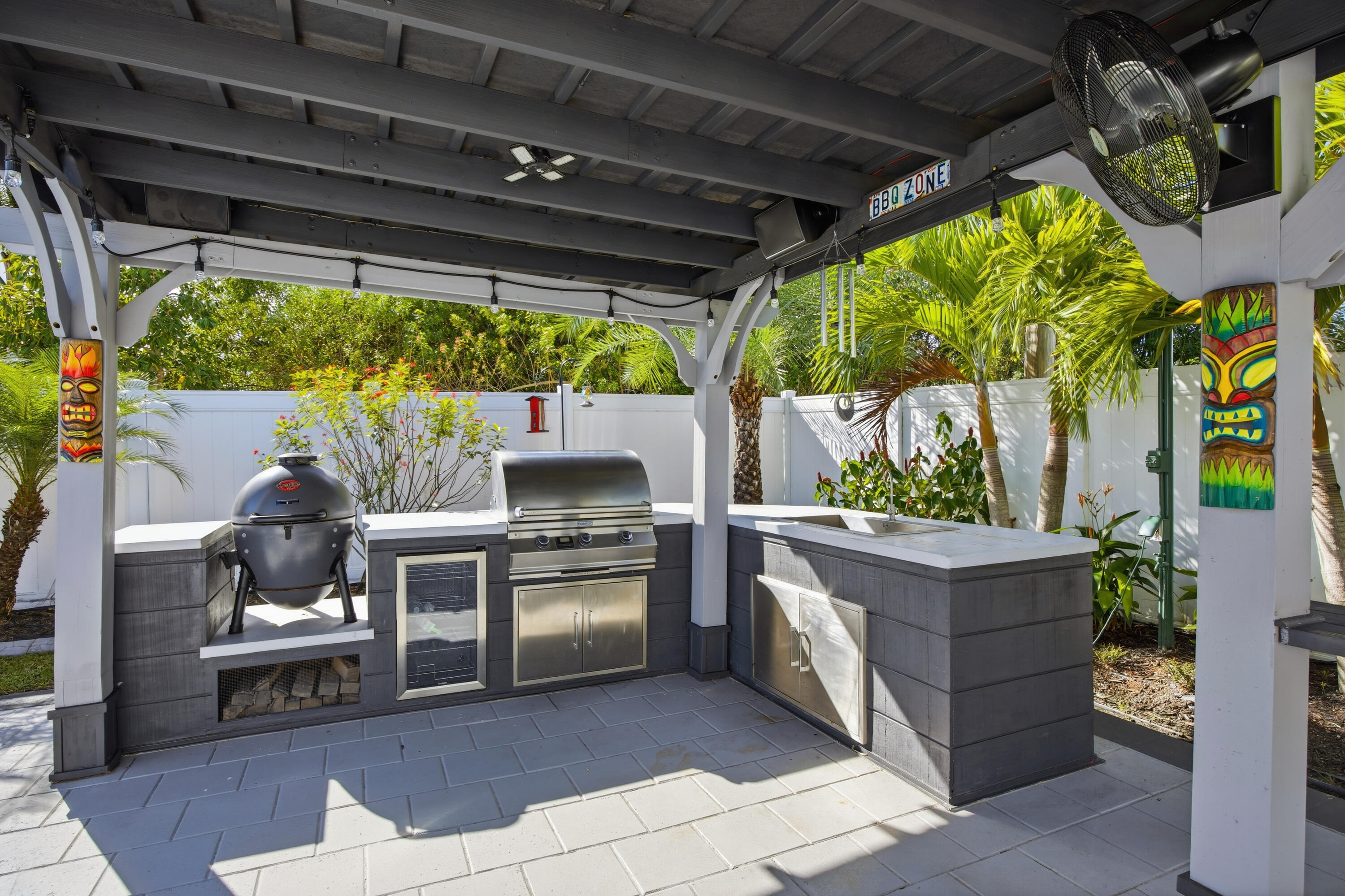 2758 Southwest Onaway Avenue Port St. Lucie, FL 34987 - Photo 42 of 49 a living room with a couch a lawn chair and a dining table with garden view
