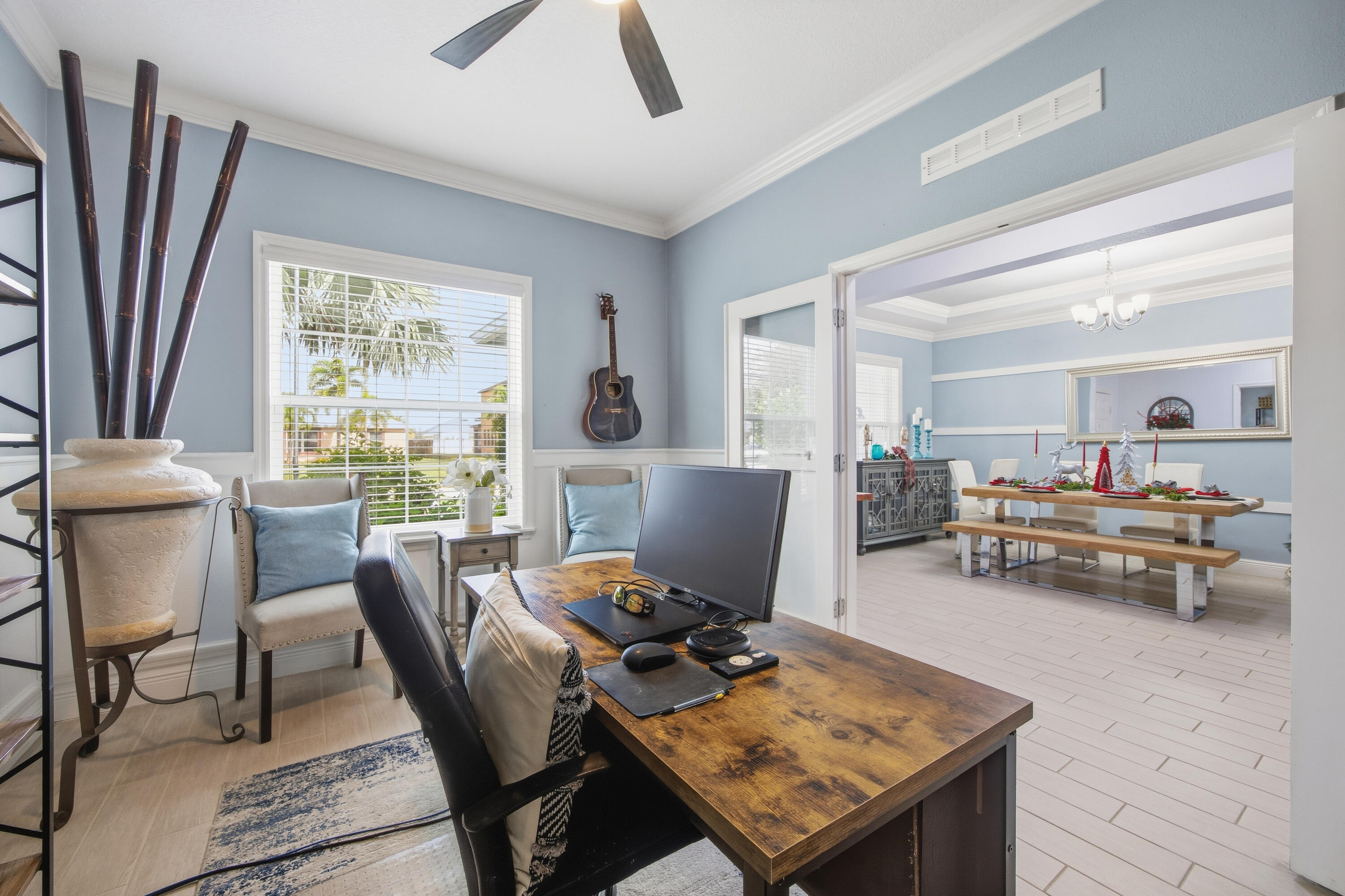 2758 Southwest Onaway Avenue Port St. Lucie, FL 34987 - Photo 8 of 49 a view of a workspace with furniture and a livingroom