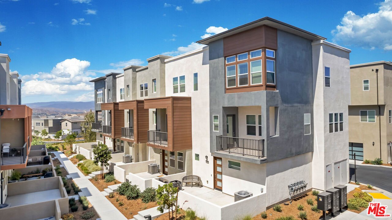 27009 Hummingbird Lane Valencia, CA 91381 - Photo 1 of 35 a large building with a clock on the wall