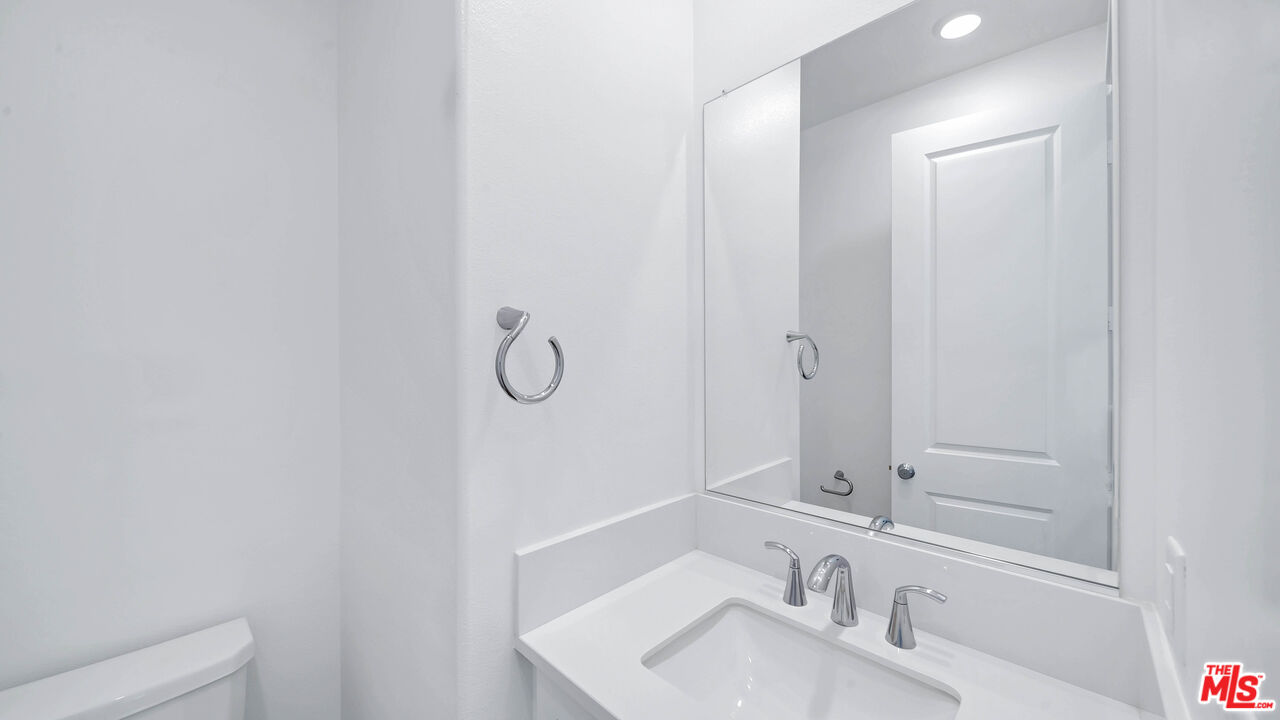 27009 Hummingbird Lane Valencia, CA 91381 - Photo 19 of 35 a bathroom with a sink and a mirror