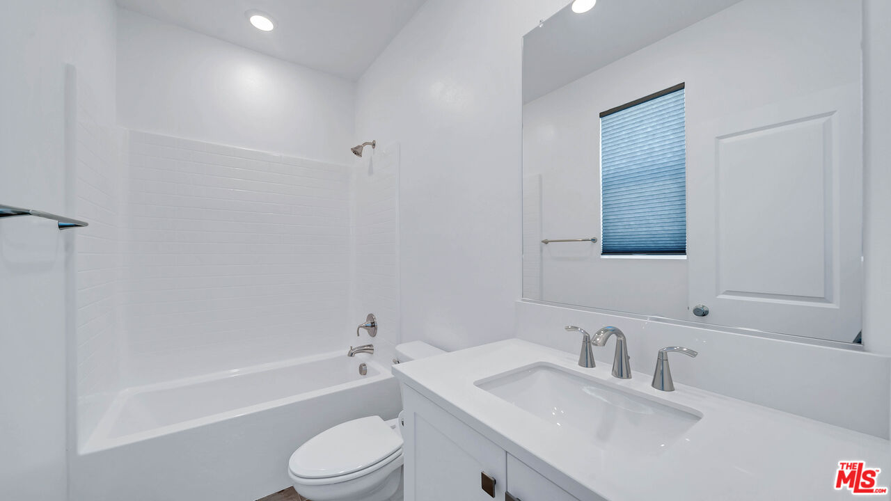 27009 Hummingbird Lane Valencia, CA 91381 - Photo 24 of 35 a bathroom with a granite countertop sink toilet and bathtub