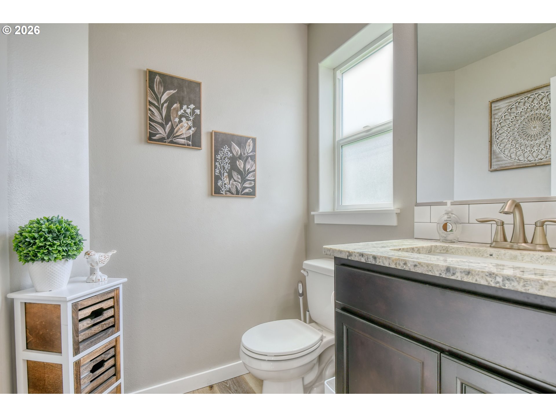 233 East Jefferson Street Athena, OR 97813 - Photo 27 of 36 a bathroom with a granite countertop toilet sink and mirror