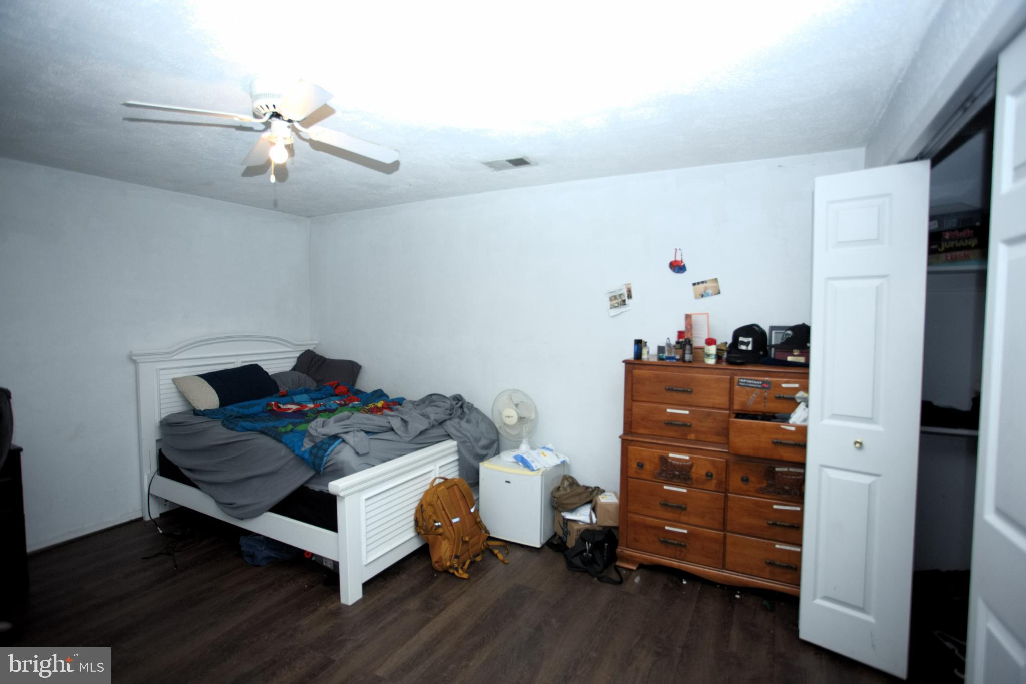 542 Chisholm Trail Lusby, MD 20657 - Photo 11 of 29 a bedroom with a bed and wooden floor