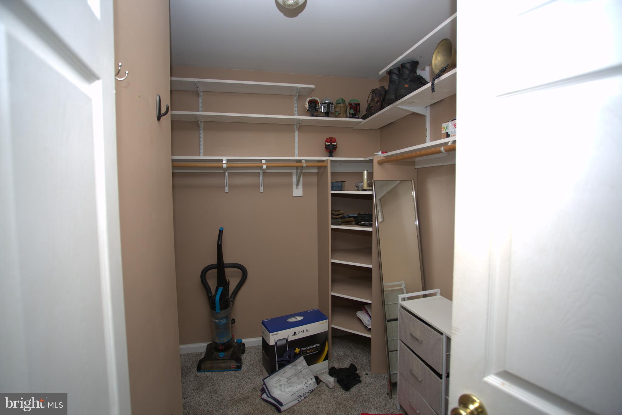 542 Chisholm Trail Lusby, MD 20657 - Photo 16 of 29 a view of walk in closet with empty racks