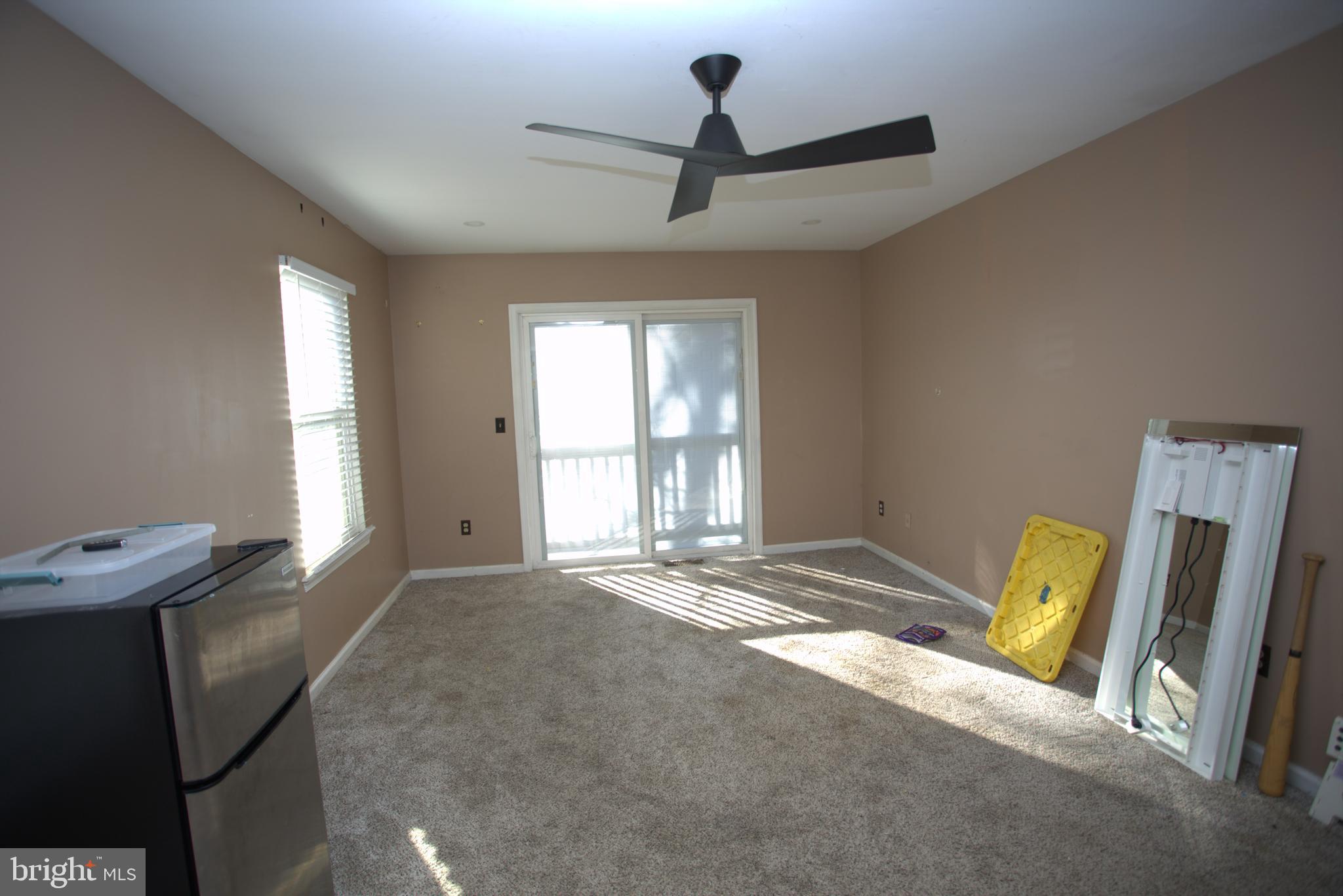 542 Chisholm Trail Lusby, MD 20657 - Photo 18 of 29 a bedroom with a bed and wooden floor