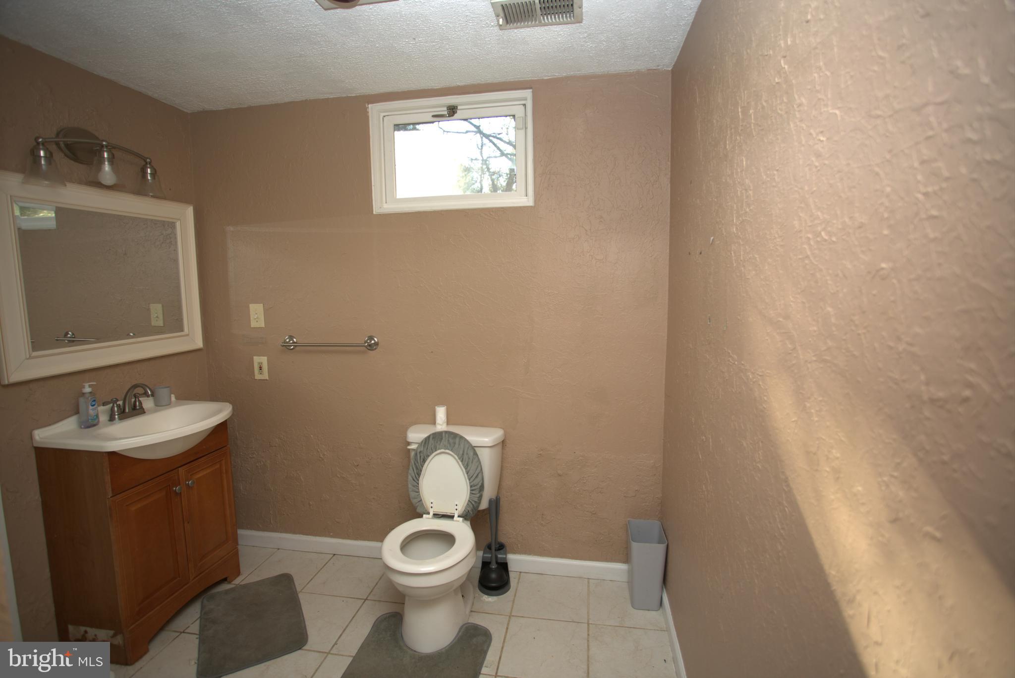 542 Chisholm Trail Lusby, MD 20657 - Photo 20 of 29 a bathroom with a sink and a mirror