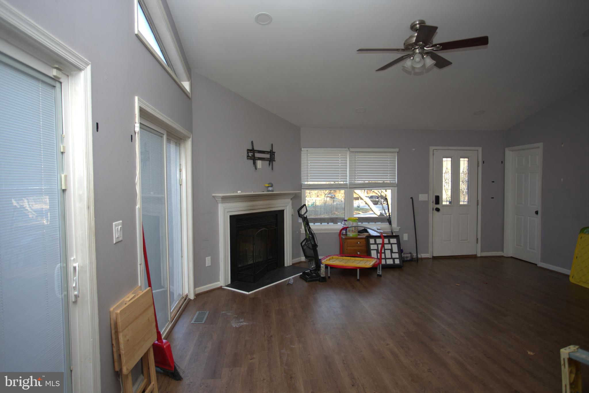 542 Chisholm Trail Lusby, MD 20657 - Photo 2 of 29 a view of a livingroom with furniture a fireplace window and wooden floor
