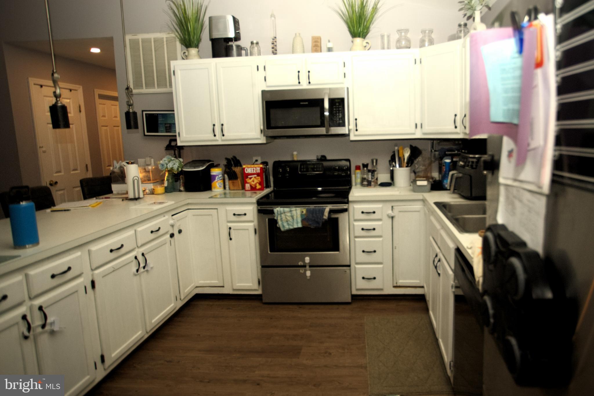 542 Chisholm Trail Lusby, MD 20657 - Photo 5 of 29 a kitchen with stainless steel appliances white cabinets and a sink