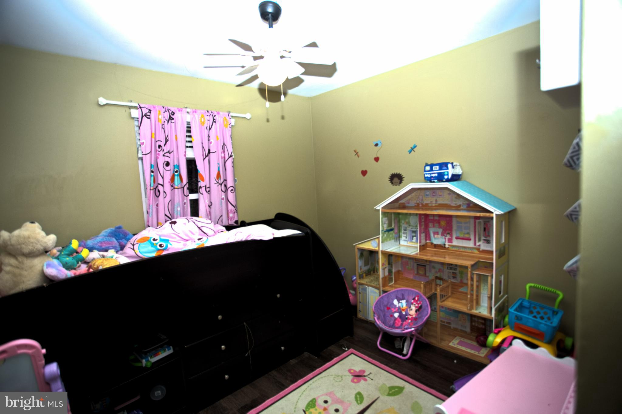 542 Chisholm Trail Lusby, MD 20657 - Photo 6 of 29 a bedroom with a bed and a dresser in it