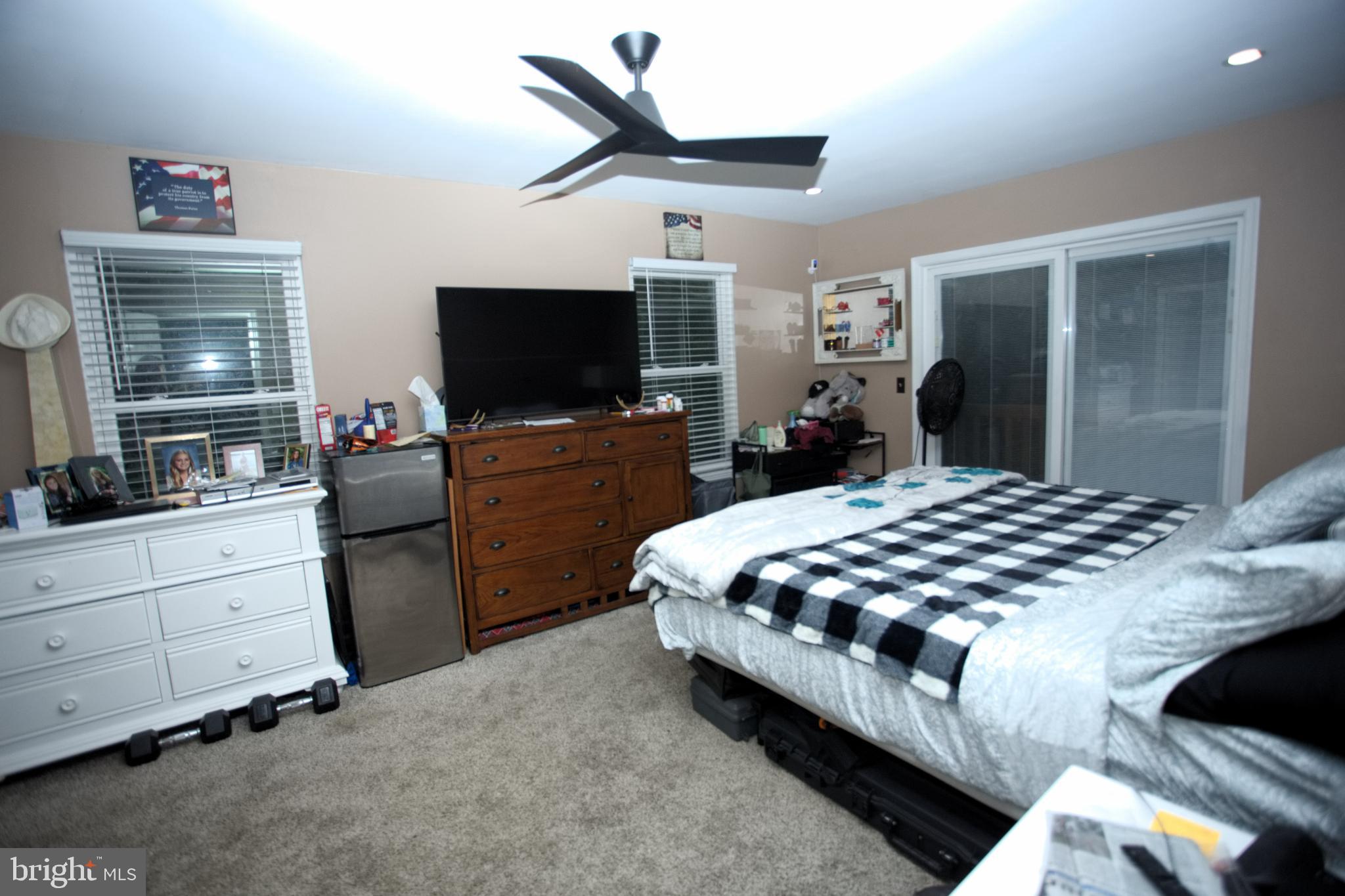 542 Chisholm Trail Lusby, MD 20657 - Photo 7 of 29 a bedroom with a bed and a flat screen tv