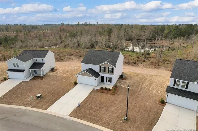 an aerial view of a house with a yard