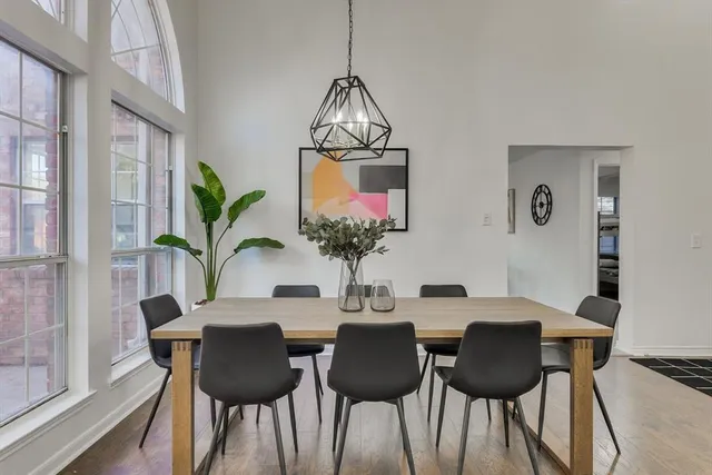 a dining room with furniture and wooden floor