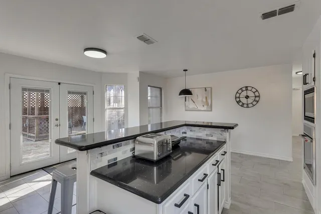 a kitchen with a sink and a refrigerator