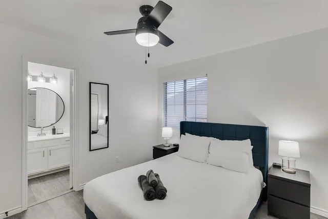 a bedroom with a bed and a chandelier