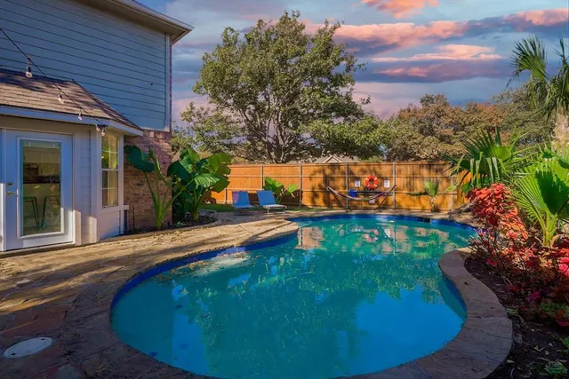 a view of a swimming pool with an outdoor seating area