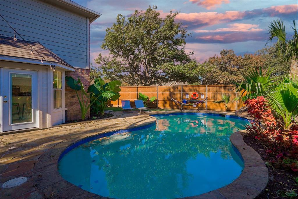 4402 Goodwin Drive Grand Prairie, TX 75052 - Photo 31 of 39 a view of a swimming pool with an outdoor seating area