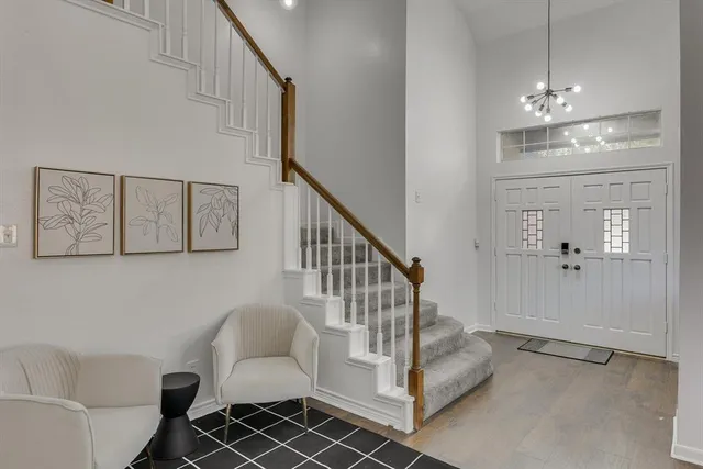 a view of hall way with furniture and stairs