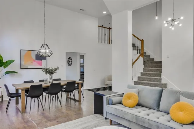 a living room with furniture and a chandelier