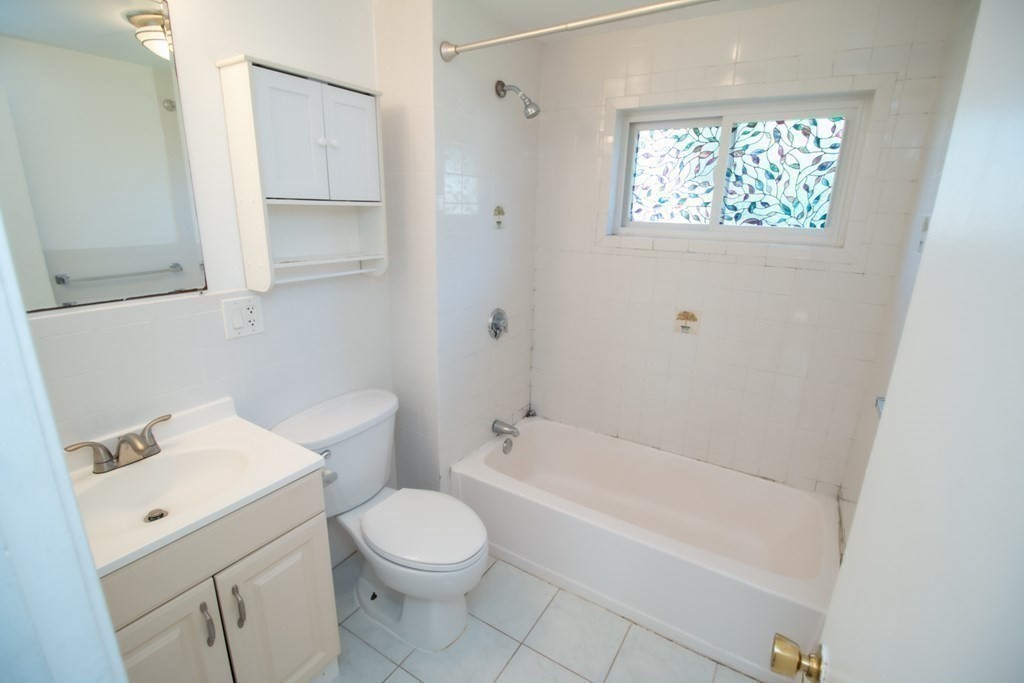 58 Bishop Drive, Unit 58 Framingham, MA 01702 - Photo 11 of 13 a bathroom with a sink toilet and shower