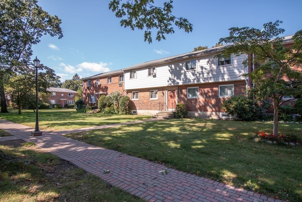58 Bishop Drive, Unit 58 Framingham, MA 01702 - Photo 2 of 13 a view of a house with a yard
