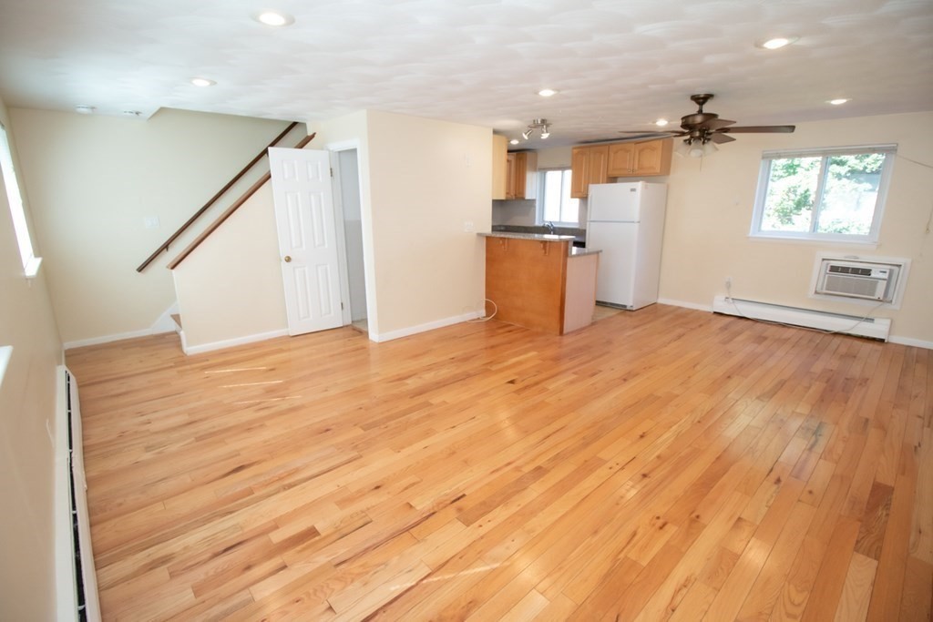 58 Bishop Drive, Unit 58 Framingham, MA 01702 - Photo 3 of 13 a view of a kitchen with a sink and a refrigerator