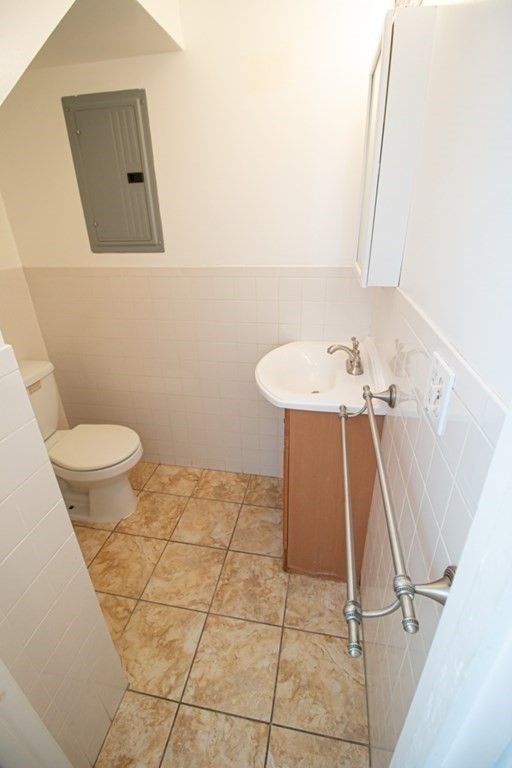 58 Bishop Drive, Unit 58 Framingham, MA 01702 - Photo 7 of 13 a bathroom with a sink a toilet and mirror
