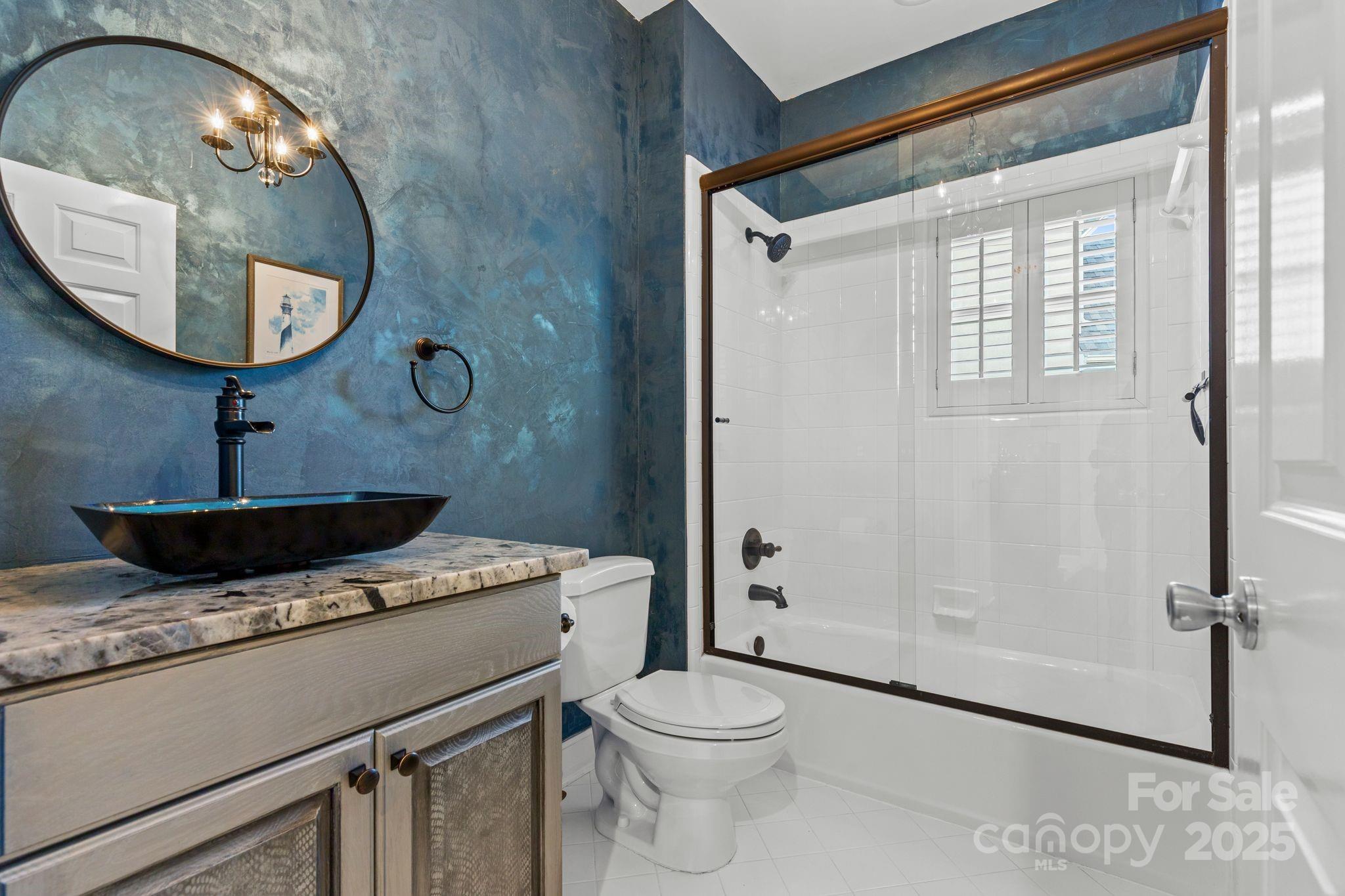 17701 Springwinds Drive Cornelius, NC 28031 - Photo 15 of 48 a bathroom with a granite countertop sink toilet and mirror