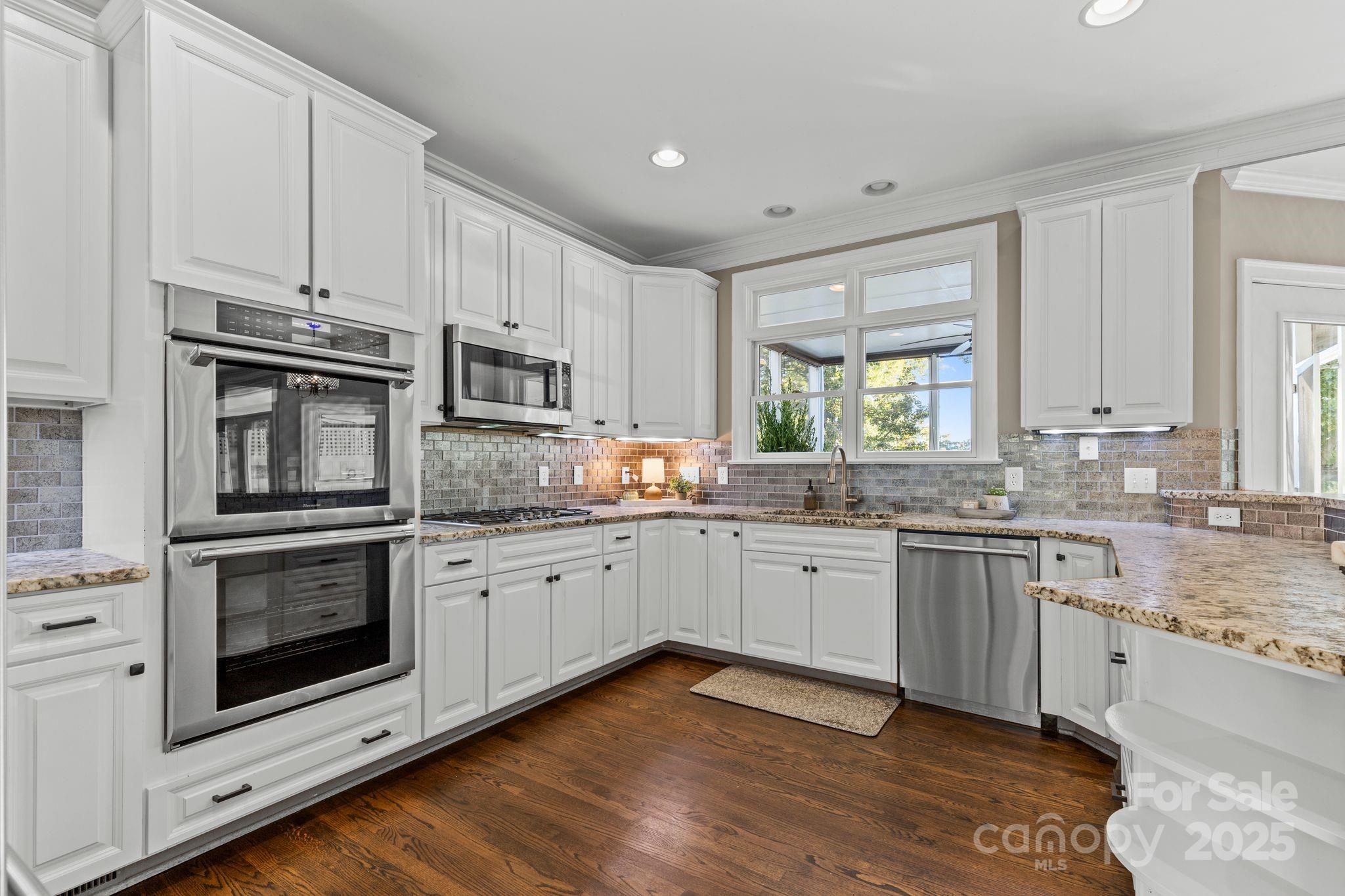 17701 Springwinds Drive Cornelius, NC 28031 - Photo 21 of 48 a kitchen with granite countertop cabinets stainless steel appliances and a sink