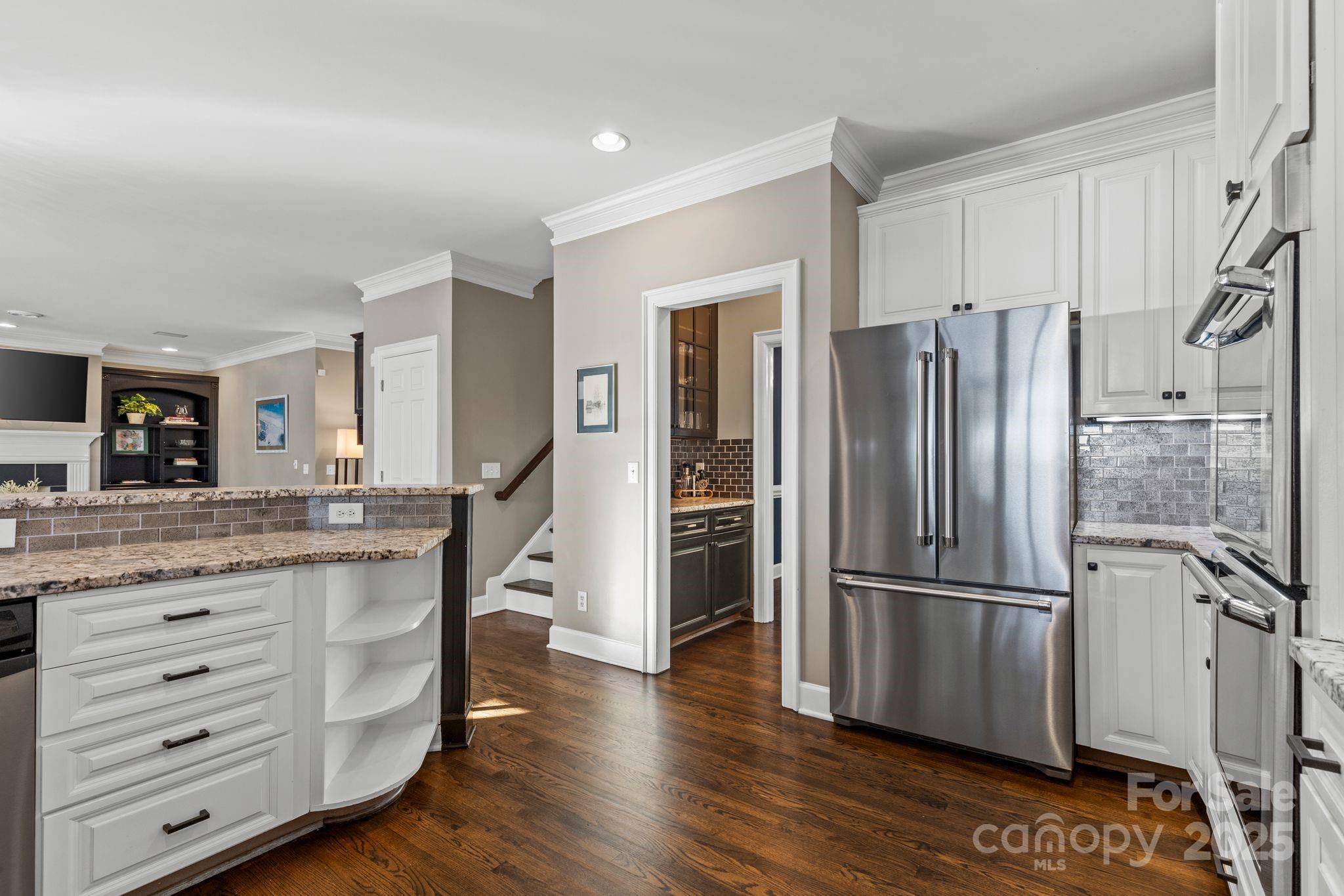 17701 Springwinds Drive Cornelius, NC 28031 - Photo 23 of 48 a kitchen with granite countertop stainless steel appliances a refrigerator and cabinets
