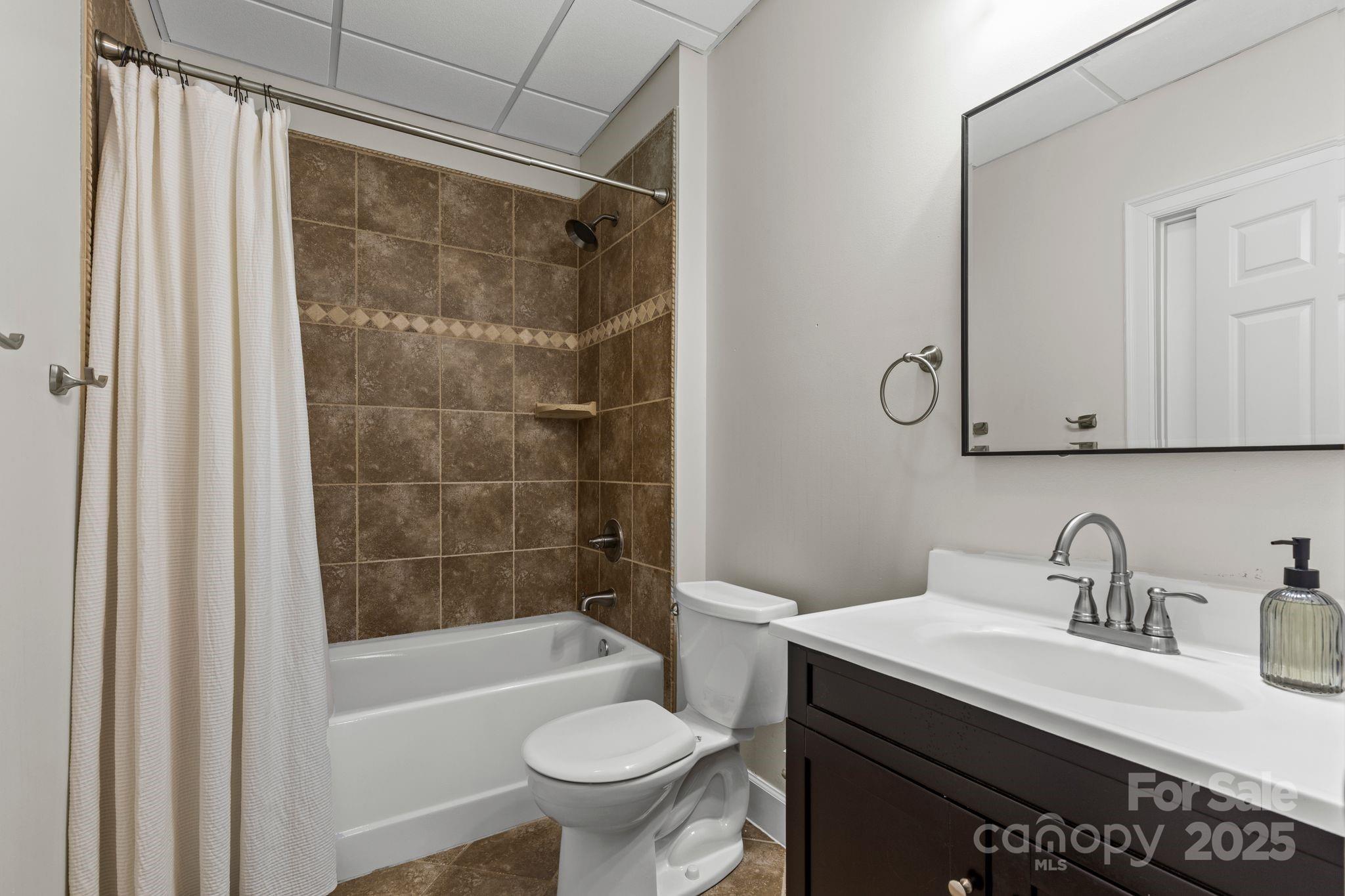 17701 Springwinds Drive Cornelius, NC 28031 - Photo 44 of 48 a bathroom with a sink toilet vanity and shower