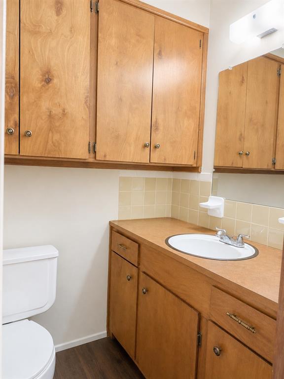2111 Quail Run, Unit A McKinney, TX 75071 - Photo 10 of 12 a bathroom with a sink a toilet and mirror
