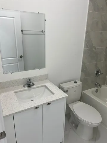 a bathroom with a sink a toilet and bathtub