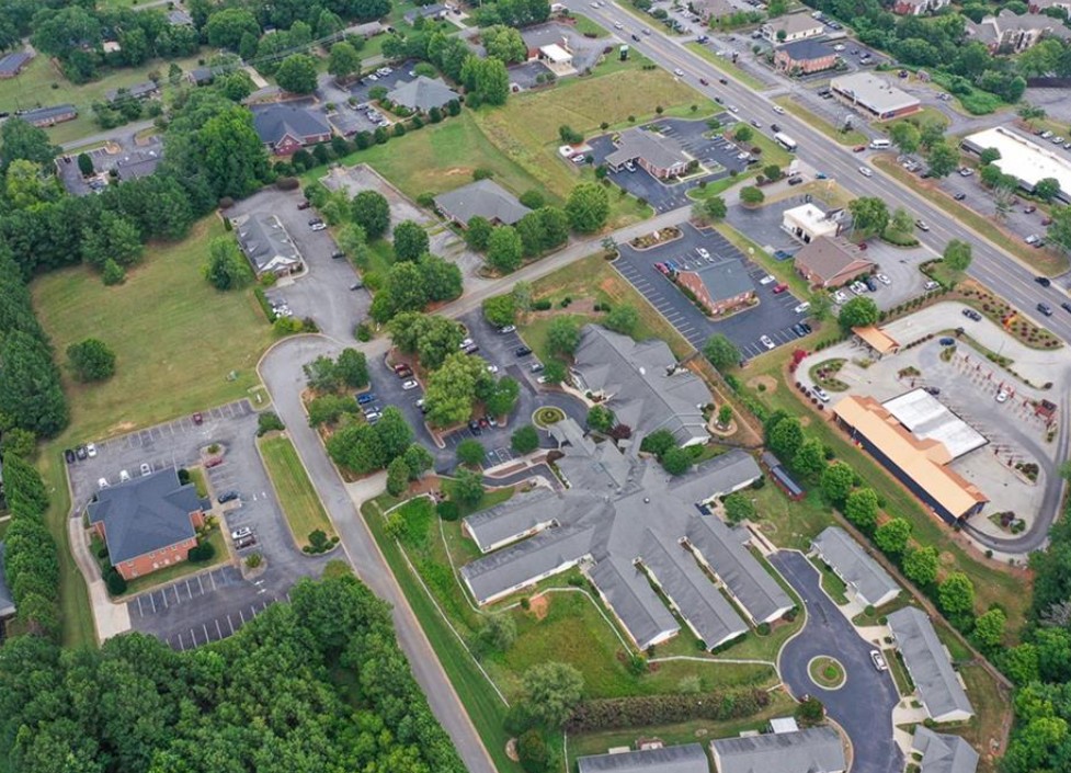 120 Perpetual Square Drive Anderson, SC 29621 - Photo 14 of 14 An aerial perspective reveals a vibrant neighborhood with diverse structures, ample parking, and well-maintained green spaces.