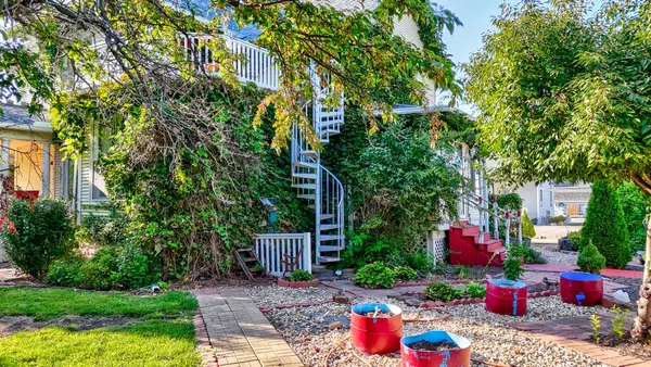 a view of a backyard with plants and a patio