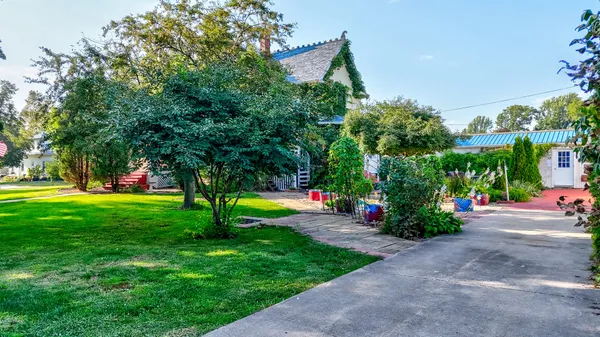an aerial view of house with yard and swimming pool
