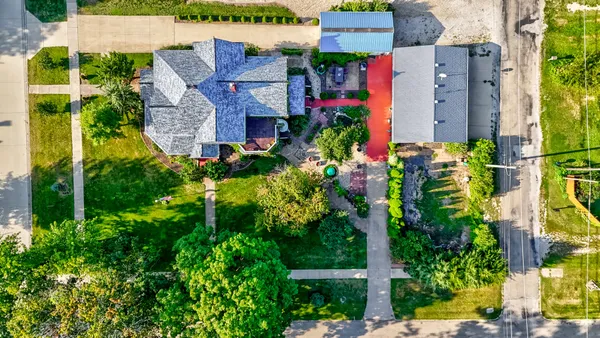 a kitchen with stainless steel appliances granite countertop a refrigerator a stove a sink and a microwave