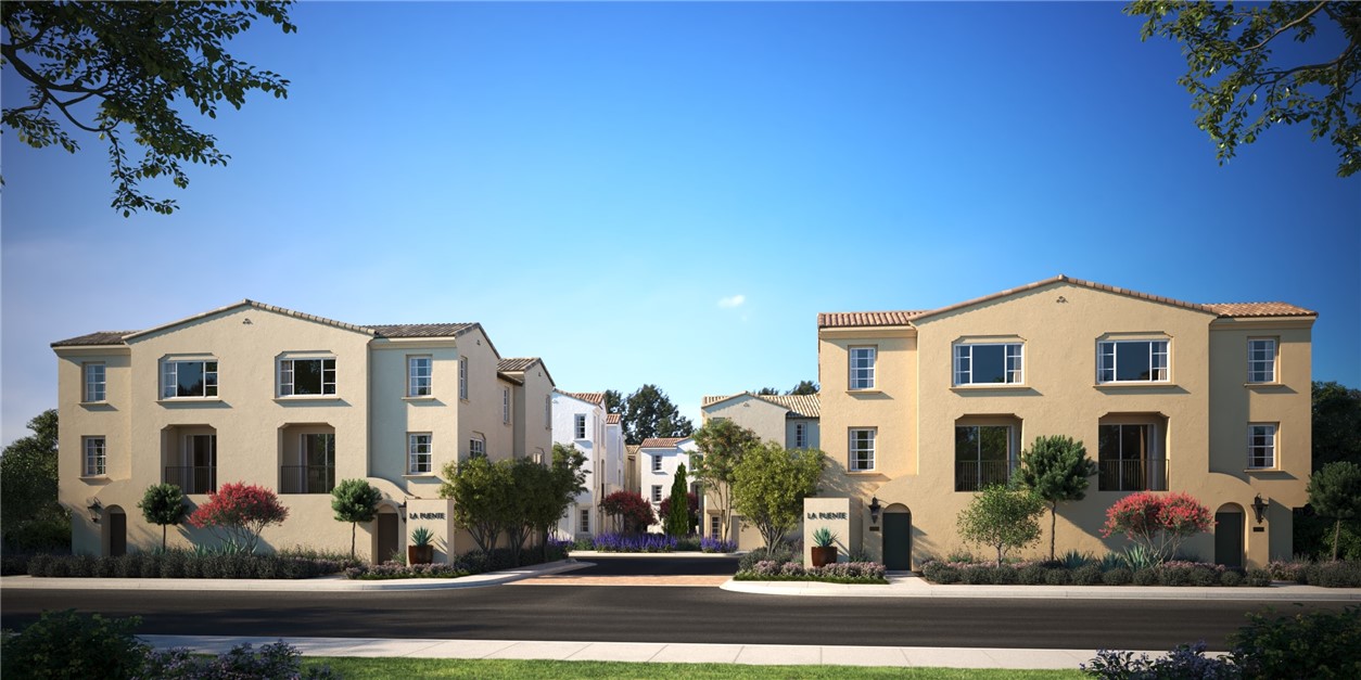 front view of a white building with potted plants